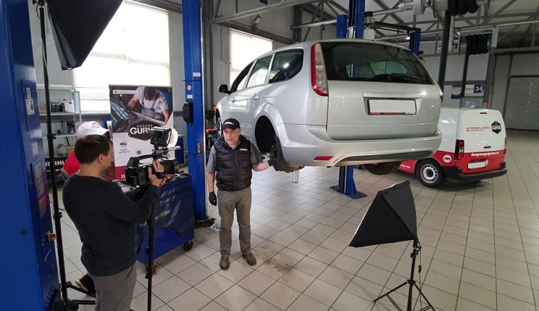 Master technician recording automotive video about braking parts