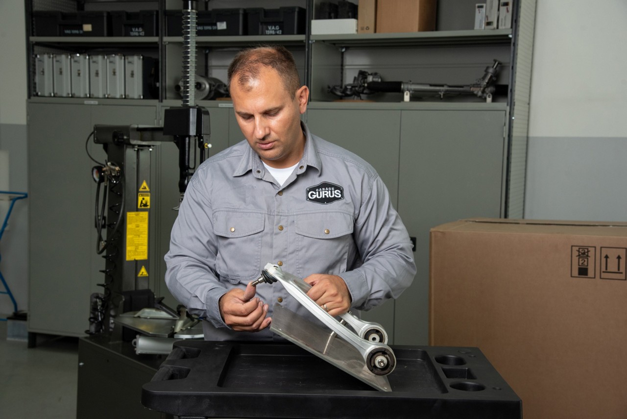Garage Gurus examining automotive components for warranty claim