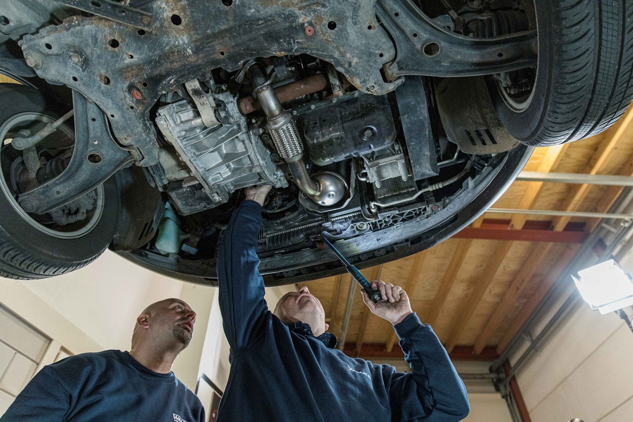 Walker_04_LR Mechanics checking emissions control system