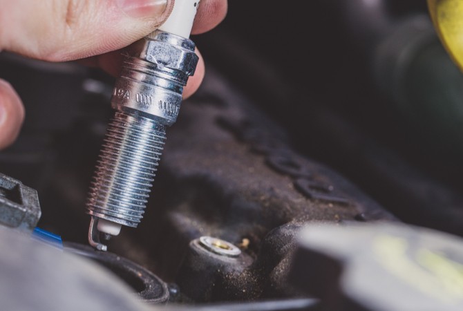 mechanic-installing-spark-plug mechanic-installing-spark-plug